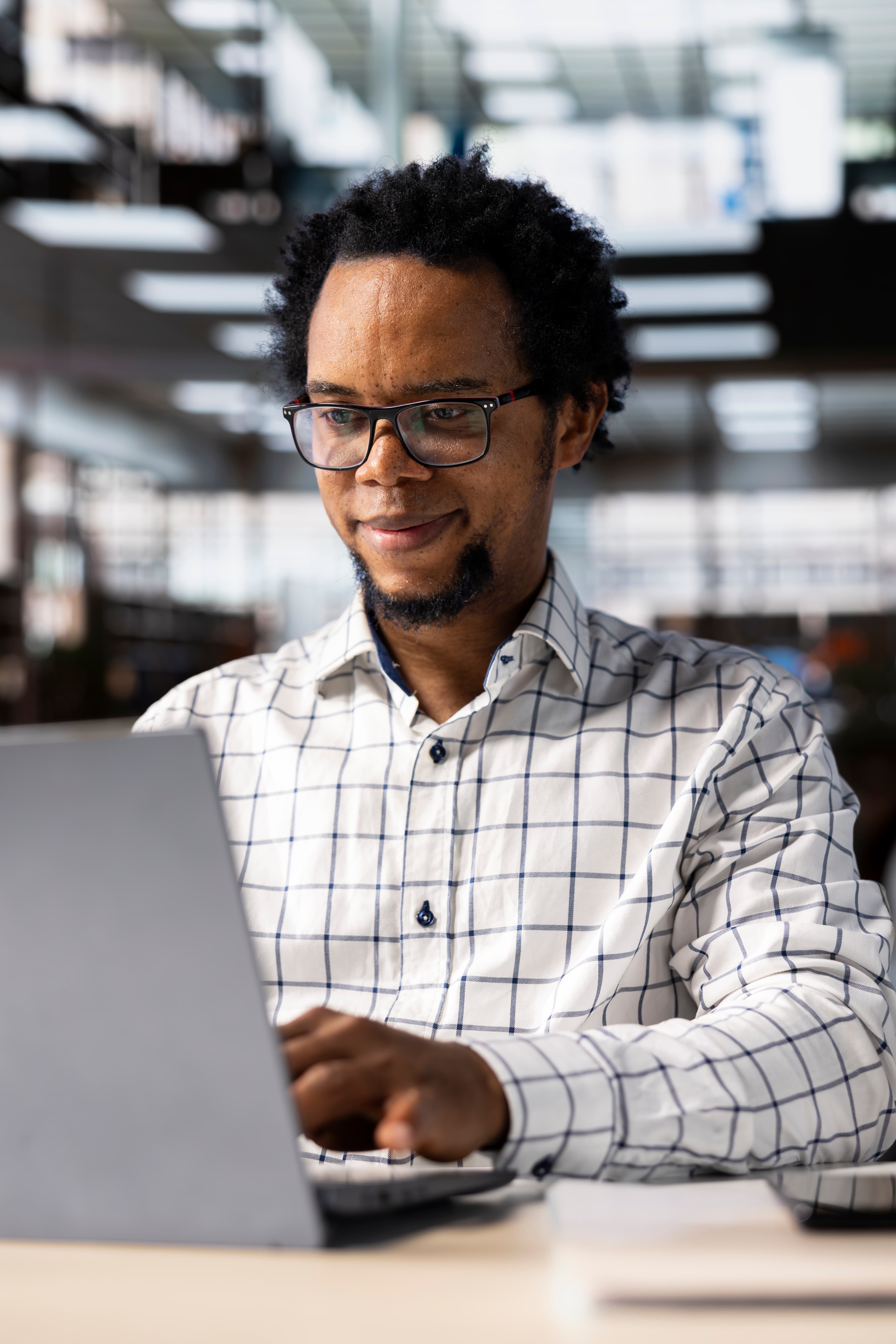 Engineer focused on work at a laptop.